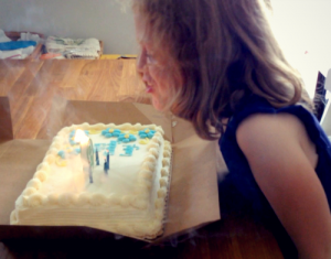 Blowing out the candles on her birthday cake